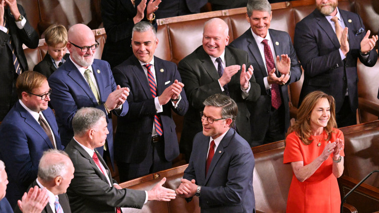 House Speaker Mike Johnson receives applause after winning the vote 