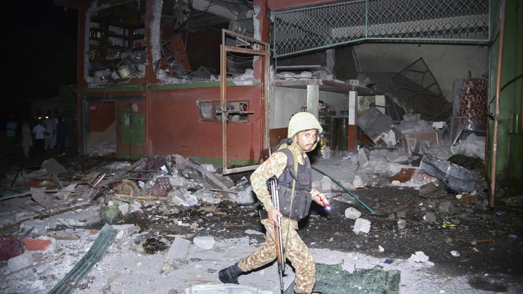 An army soldier examines a building damaged by a suspected Indian missile attack near Muzaffarabad, the capital of Pakistan controlled Kashmir