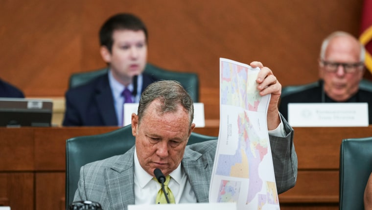 Terry M. Wilson looks through maps during a public hearing