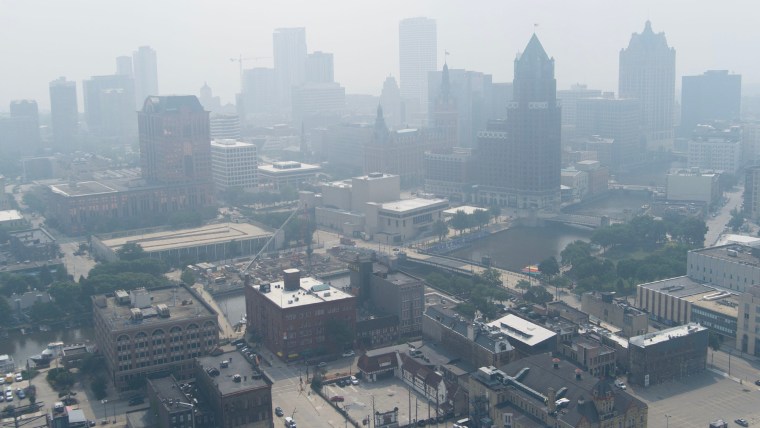 Aerial view of a blanket of smoke filling the air above buildings