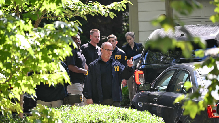FBI agents are seen outside John Bolton's house after the agency conducted a court-authorized search at his place on Aug. 22, 2025 in Bethesda, Md.    