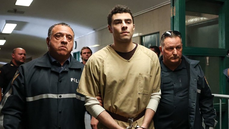 Luigi Mangione, accused of the murder of United Healthcare CEO Brian Thompson, is escorted by police as he arrives at court in New York City on September 16, 2025. 