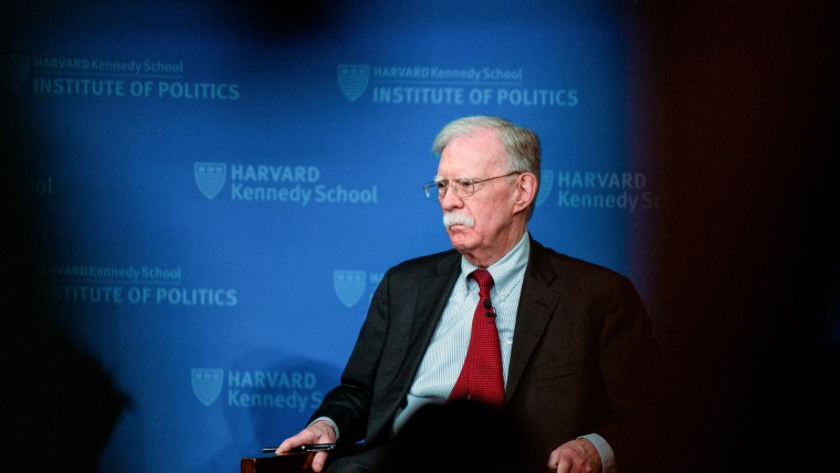 John Bolton sits on stage