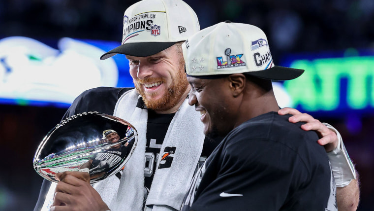  Sam Darnold #14 and Kenneth Walker III #9 of the Seattle Seahawks celebrate with the Vince Lombardi Trophy 