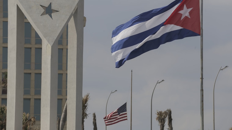 Cuban and American flags fly outside the American embassy in Havana, Cuba, Tuesday, Jan.14, 2025. 