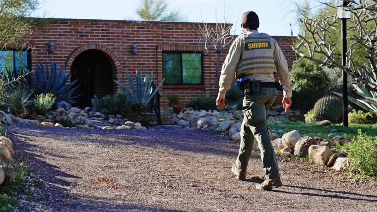 A member of the Pima County sheriff's office walks outside of Nancy Guthrie's home on Feb. 9, 2026 in Tucson, Ariz. 