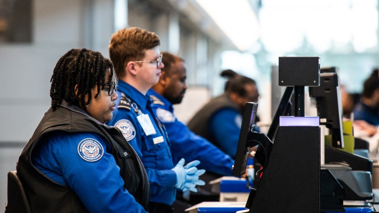 TSA agents seated at their stations