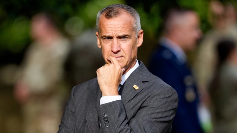 Corey Lewandowski stands outside, places hand on his chin