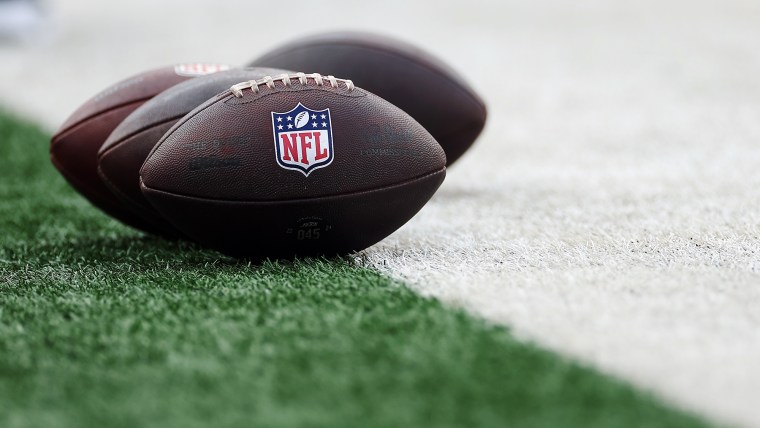 Detail of Wilson footballs with the NFL logo set on the football field