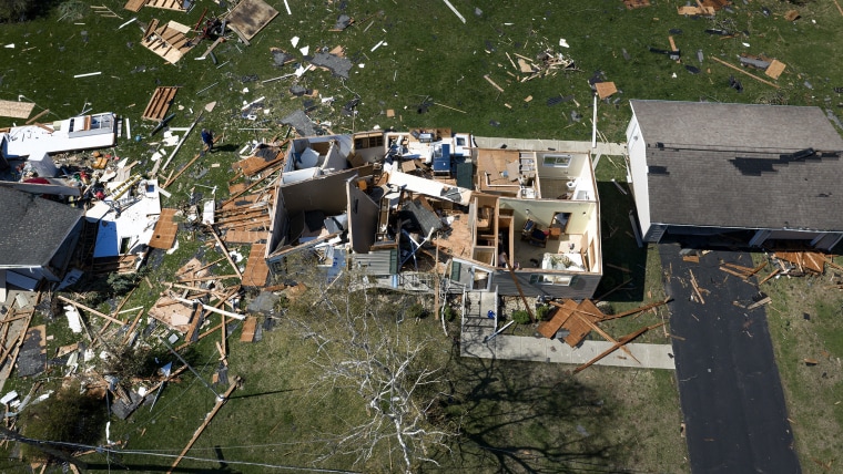 An aerial view of a destroyed house with no roof.