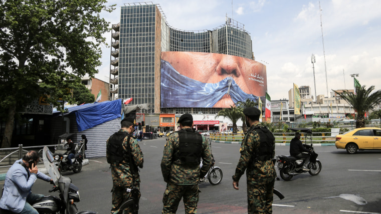 Soldiers standing in a central intersection in Tehran.