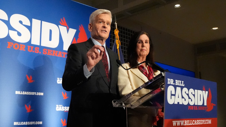 Image: Sen. Bill Cassidy, R-La., left, speaks to supporters alongside his wife, Laura, during an election night watch party.
