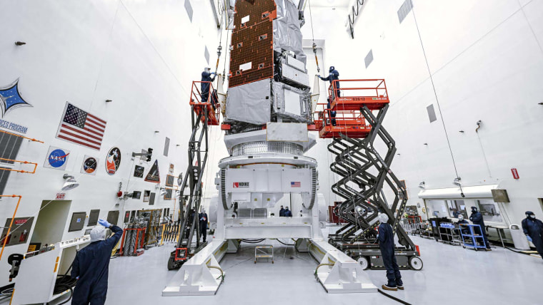 Technicians and engineers at NASA’s Kennedy Space Center in Florida use a crane to lift the agency’s Nancy Grace Roman Space Telescope to a specialized work stand Friday, June 26, 2026.