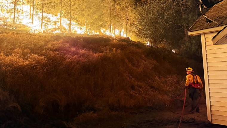 A firefighter battles the Fairview Fire in Spokane County, Wash.