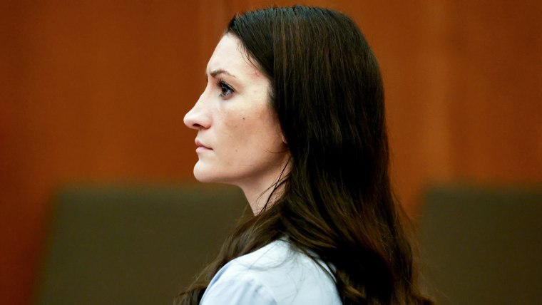 Side profile of Lindsay Clancy sitting inside of a court room
