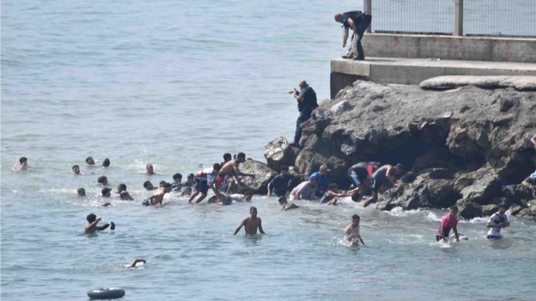 Migrants attempting to cross the border.