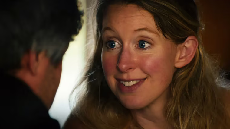 Image: Elizabeth Holmes looking into director Nathan Fielder's eyes.
