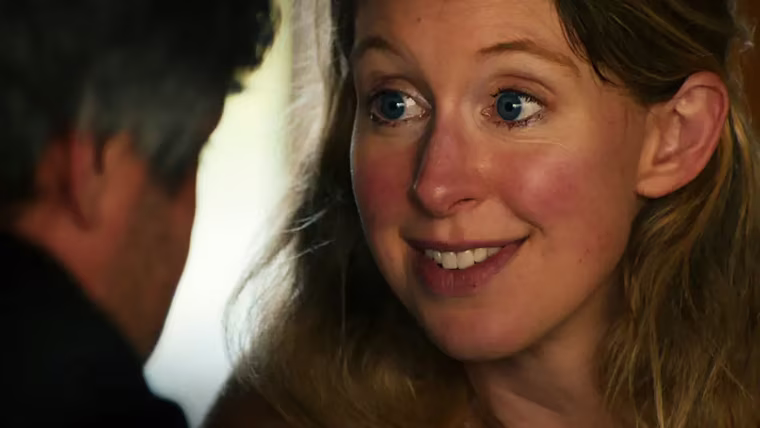 Image: Elizabeth Holmes looking into director Nathan Fielder's eyes.