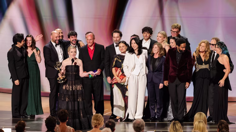 Katie Dippold and cast/crew accept an Emmy Award.