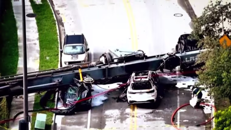 cars under a collapsed crane in Miami