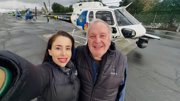 Image: Eliana Moreno and George Marciniw pose for a selfie in front of an NBCLA branded helicopter.
