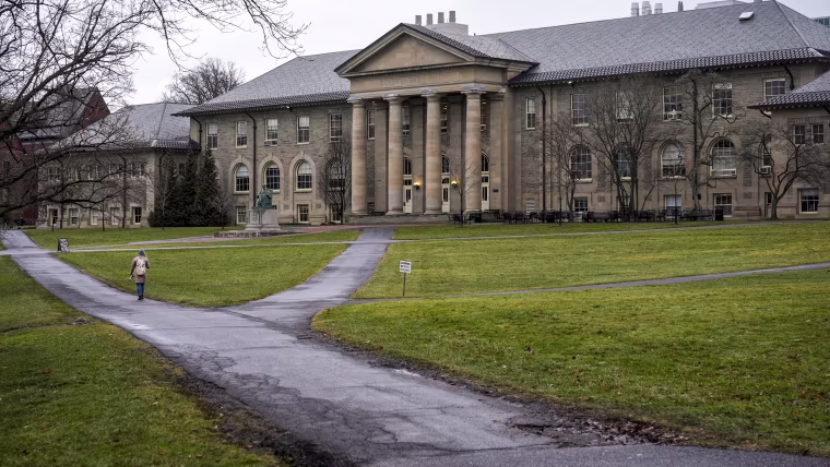 People walk on the campus of Cornell University 