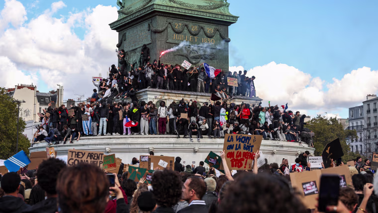 Protesters gather for a student demonstration at Place de la Bastille with a view of the Colonne de Juillet monument.