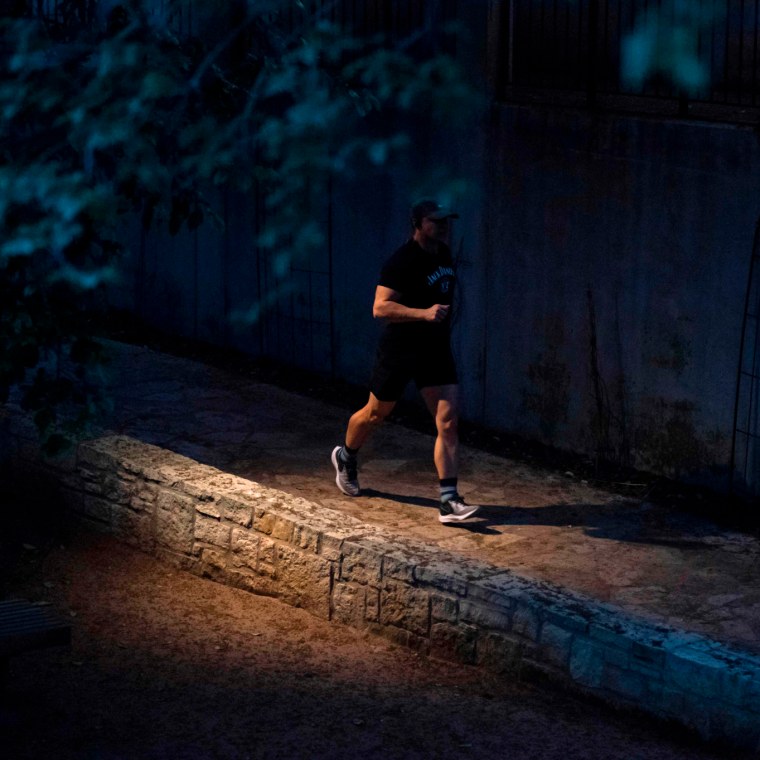 A jogger on the river walk in San Antonio, Texas.