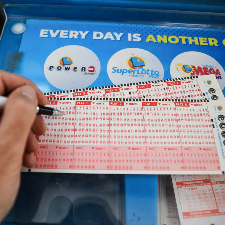 Image: A person plays the Powerball lottery in Milpitas, Calif. on November 7, 2022. The Powerball jackpot hit a record $1.9 billion.