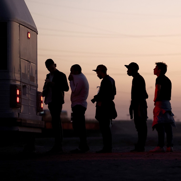Immigrants seeking asylum wait to board a bus to a U.S. Border Patrol processing center, after crossing into Arizona from Mexico, on May 11, 2023.