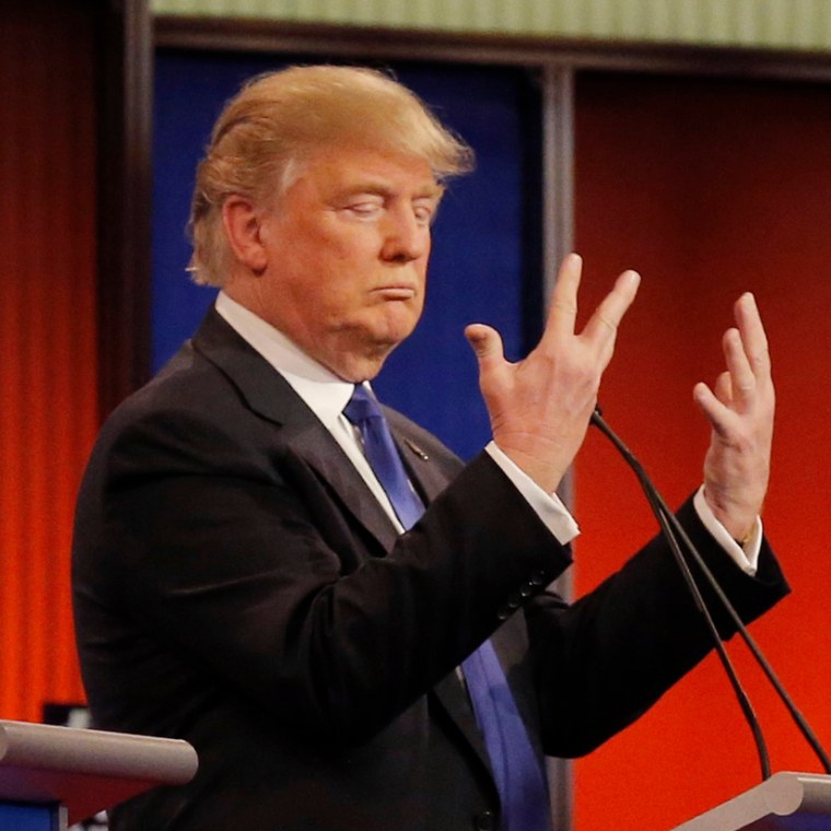Republican U.S. presidential candidate Trump shows off the size of his hands as rivals Rubio and Cruz look on at the start of the U.S. Republican presidential candidates debate in Detroit