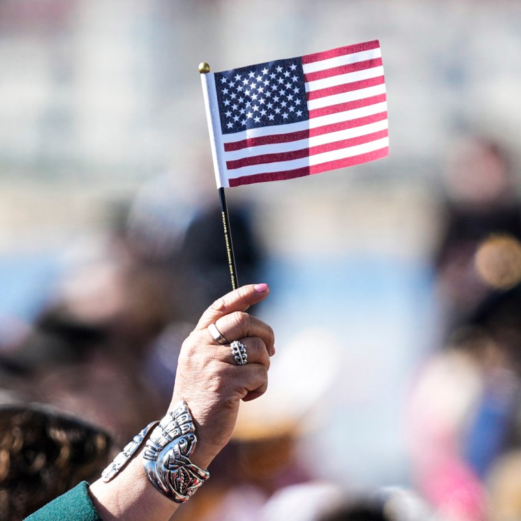 Image: People recite an oath during a naturalization ceremony on Feb. 15, 2023, in San Diego.