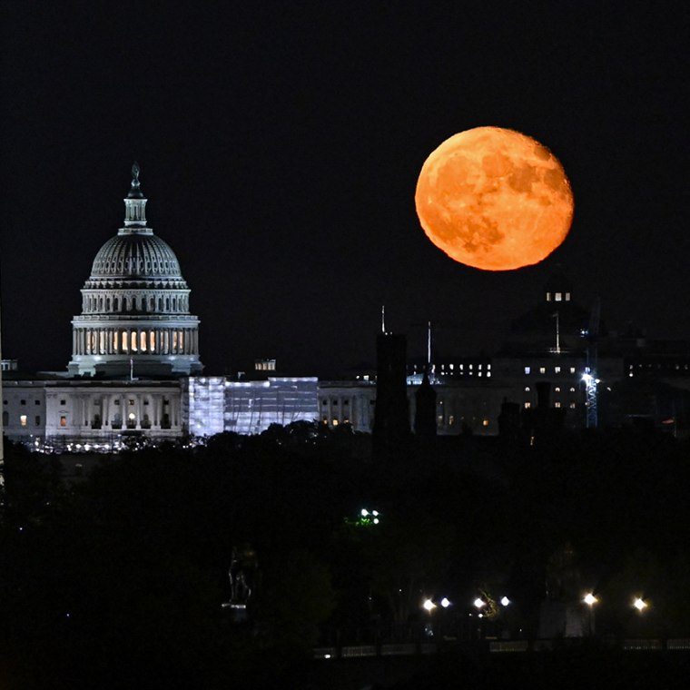 The moon rises over the Capitol