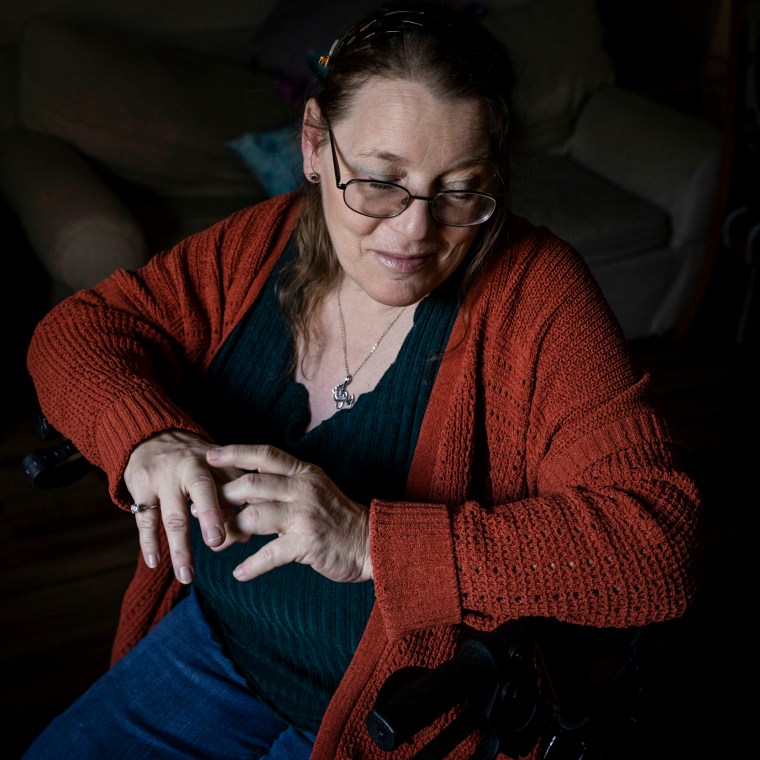 Deborah Laufer sits in her walker at her home in Florida.