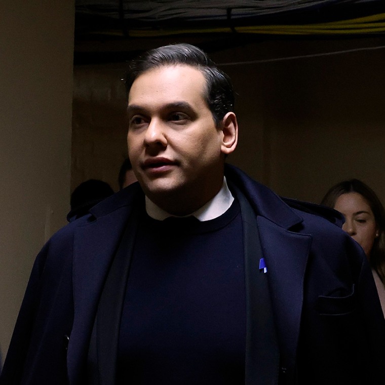 Rep. George Santos, R-N.Y., and members of his staff walk through the tunnel connecting the Capitol Hill office buildings with the U.S. Capitol ahead of a vote to expel him.