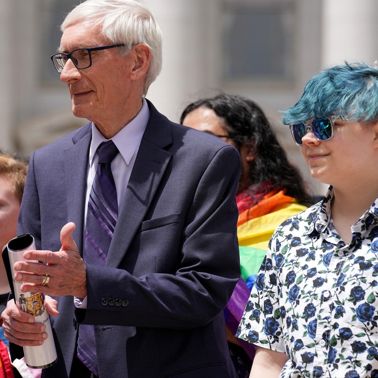 Evers with Aspen Morris at the raising of an LGBTQ flag  at the Capitol in Madison