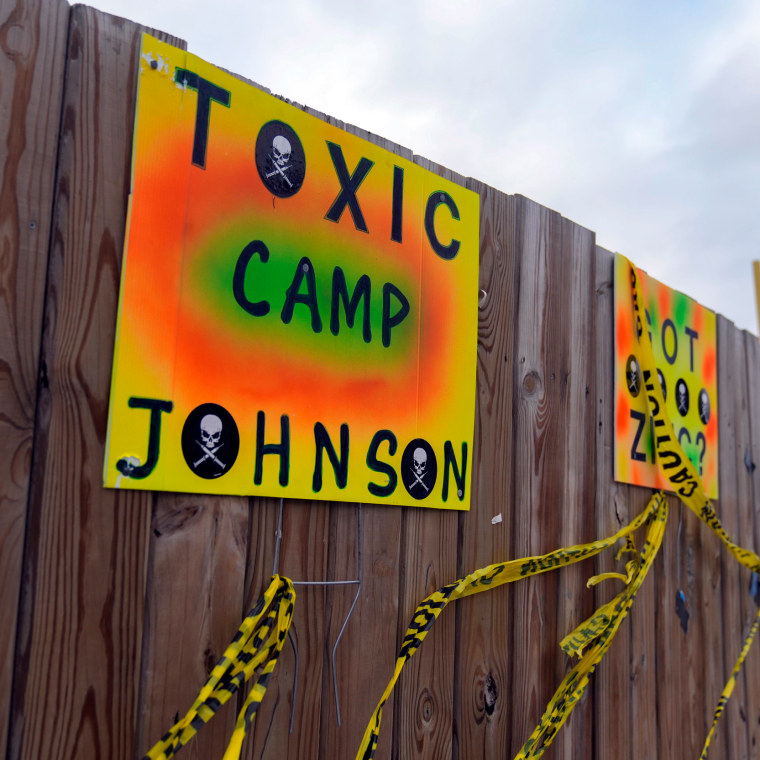 Signs protesting the construction of a government-run tent encampment for migrants are mounted in Chicago, on Dec. 4, 2023. 