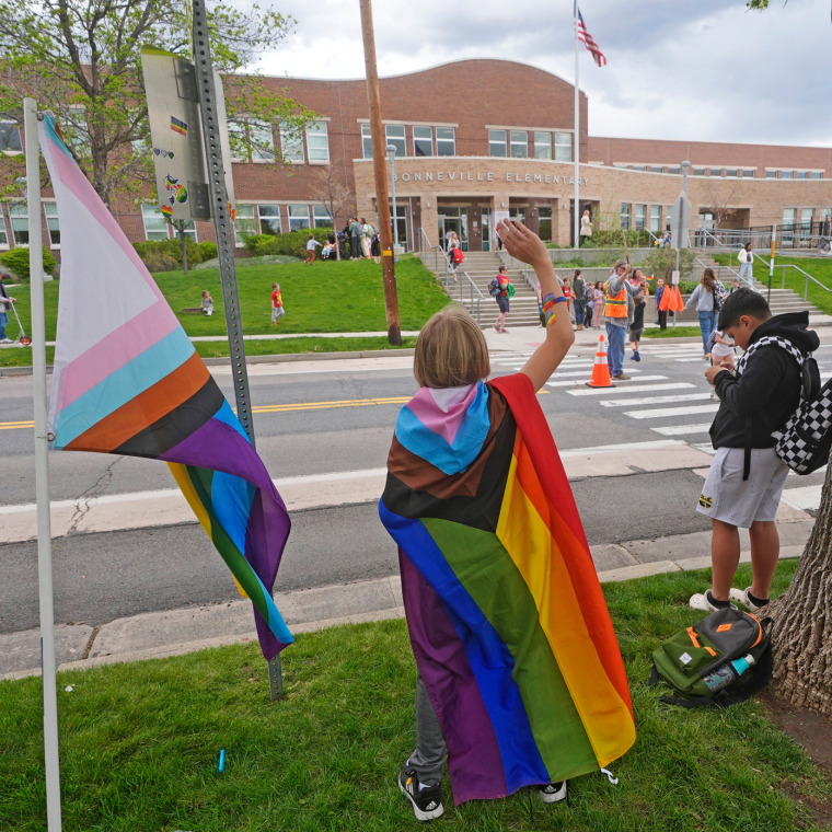 Bonneville Elementary School 5th grader Graham Beeton waves to fellow students during a block party supporting trans and non-binary students and staff.