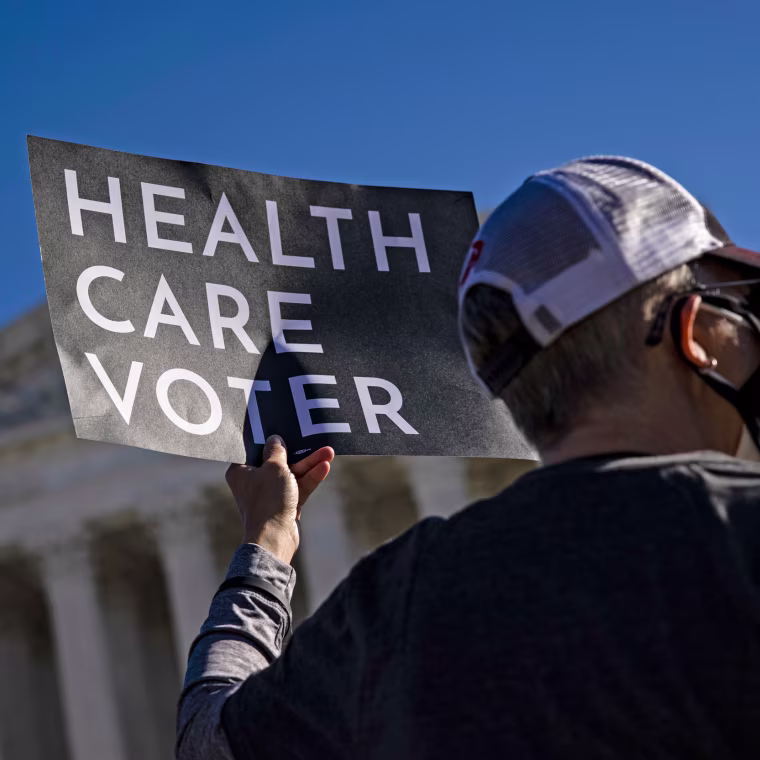 A supporter of the Affordable Care Act demonstrates in front of the Supreme Court on Nov. 10, 2020.