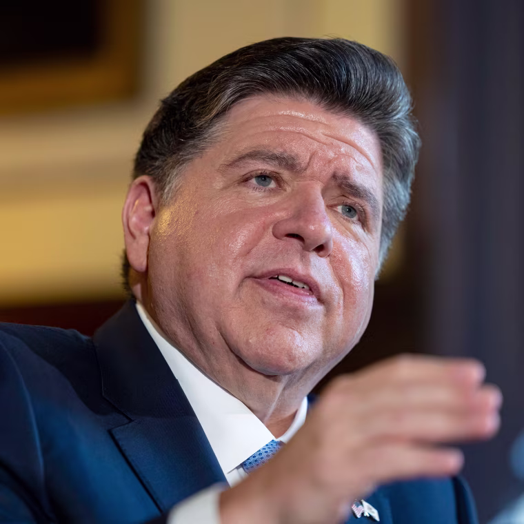 JB Pritzker speaks at a meeting.