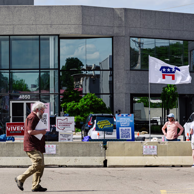A person walks past a political advocacy zone ahead of a rally for Ohio.