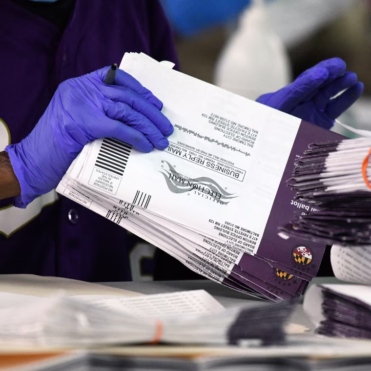Canvassers open and review mail-in and absentee ballots for the 2024 General Election at the Baltimore City Board of Elections.