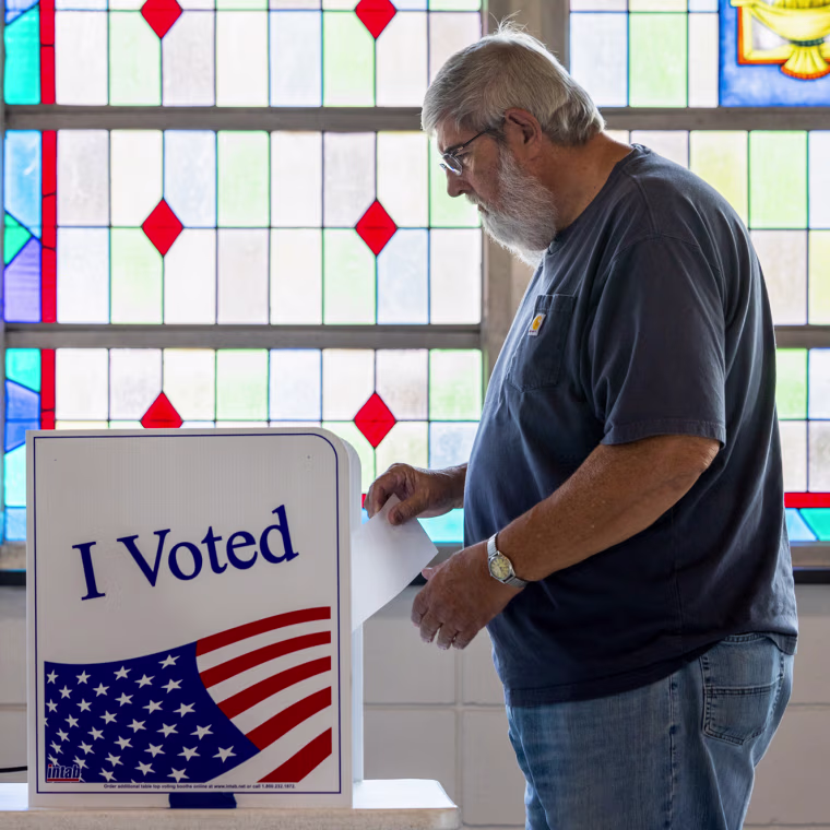 A man casting his ballot at a polling location.