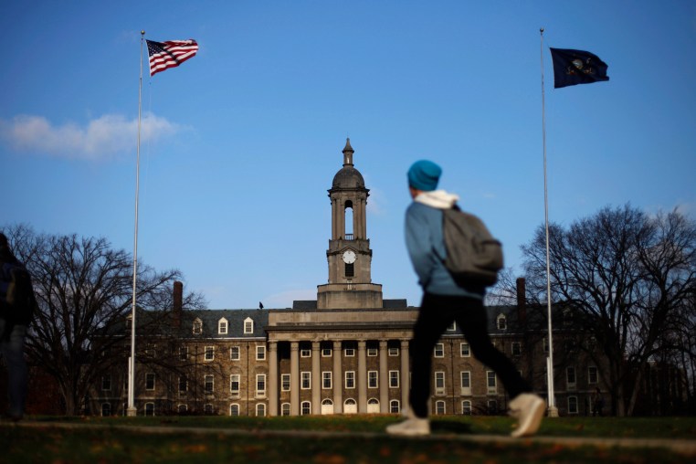 Image: A students walks in front of the Old Main building on the Penn State University campus Friday, Nov. 11, 2011, in State College, Pa.