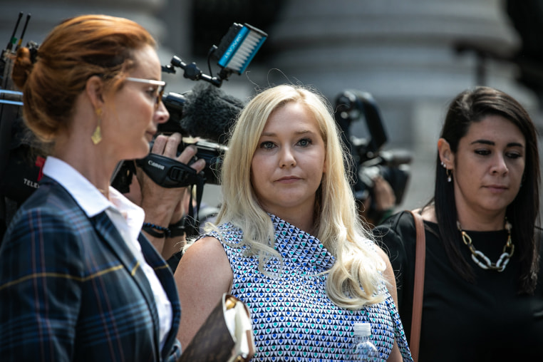 Virginia Giuffre, an alleged victim of Jeffrey Epstein, center, exits from federal court in New York on Aug. 27, 2019.