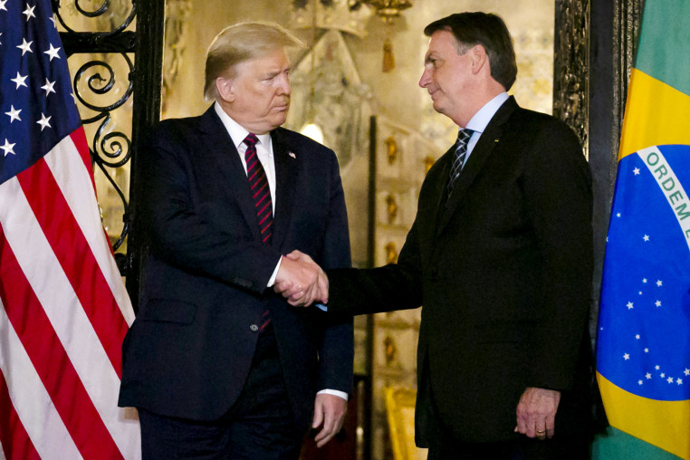 President Donald Trump shakes hands with Brazil's President Jair Bolsonaro at Trump's Mar-a-Lago resort on March 7, 2020.