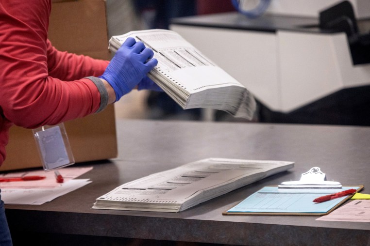 Election workers sort ballots at the Maricopa County Tabulation and Election Center in Phoenix