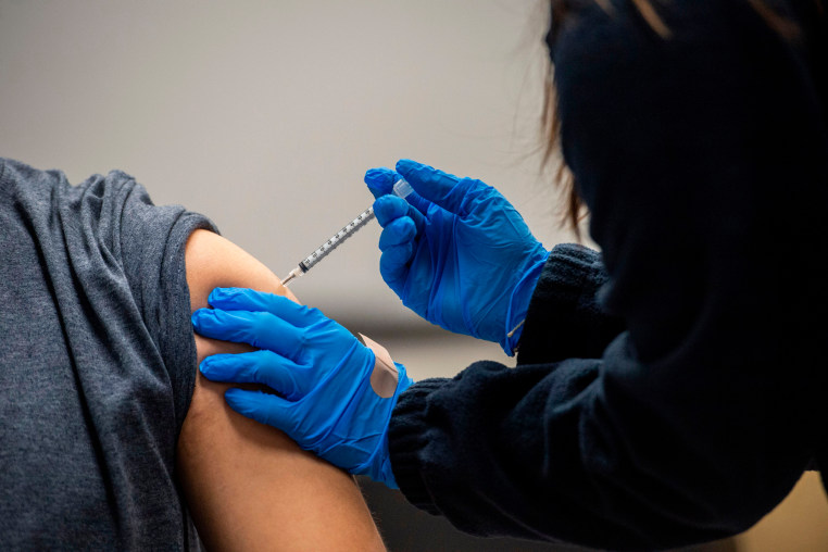 A man receives a Pfizer-BioNTech Covid-19 vaccine in Chelsea, Mass