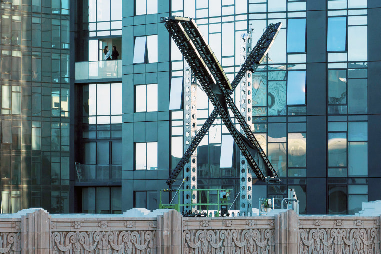 A partially completed "X" sign rests atop the company headquarters, formerly known as Twitter, in downtown San Francisco, on Friday, July 28, 2023. San Francisco has launched an investigation into the sign as city officials say replacing letters or symbols on buildings, or erecting a sign on top of one, requires a permit. (AP Photo/Noah Berger)