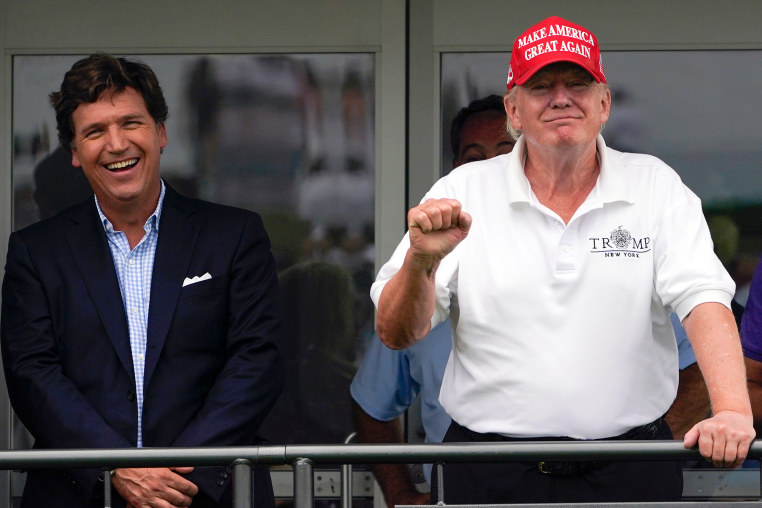 Tucker Carlson, left, and Donald Trump at the Bedminster Invitational LIV Golf tournament in Bedminster, N.J.,